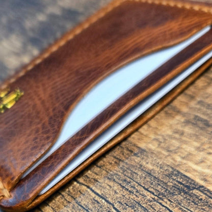 Brown leather wallet on a wooden surface